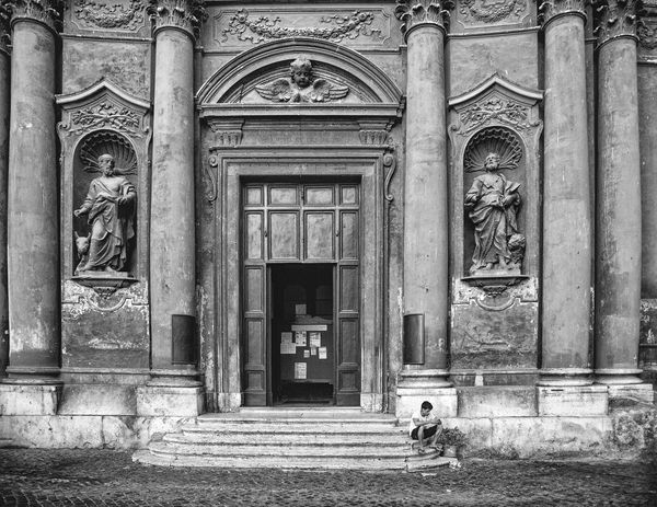 Man sitting on church steps in Rome